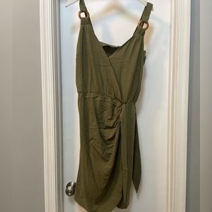 Green dress with wooden details on straps
